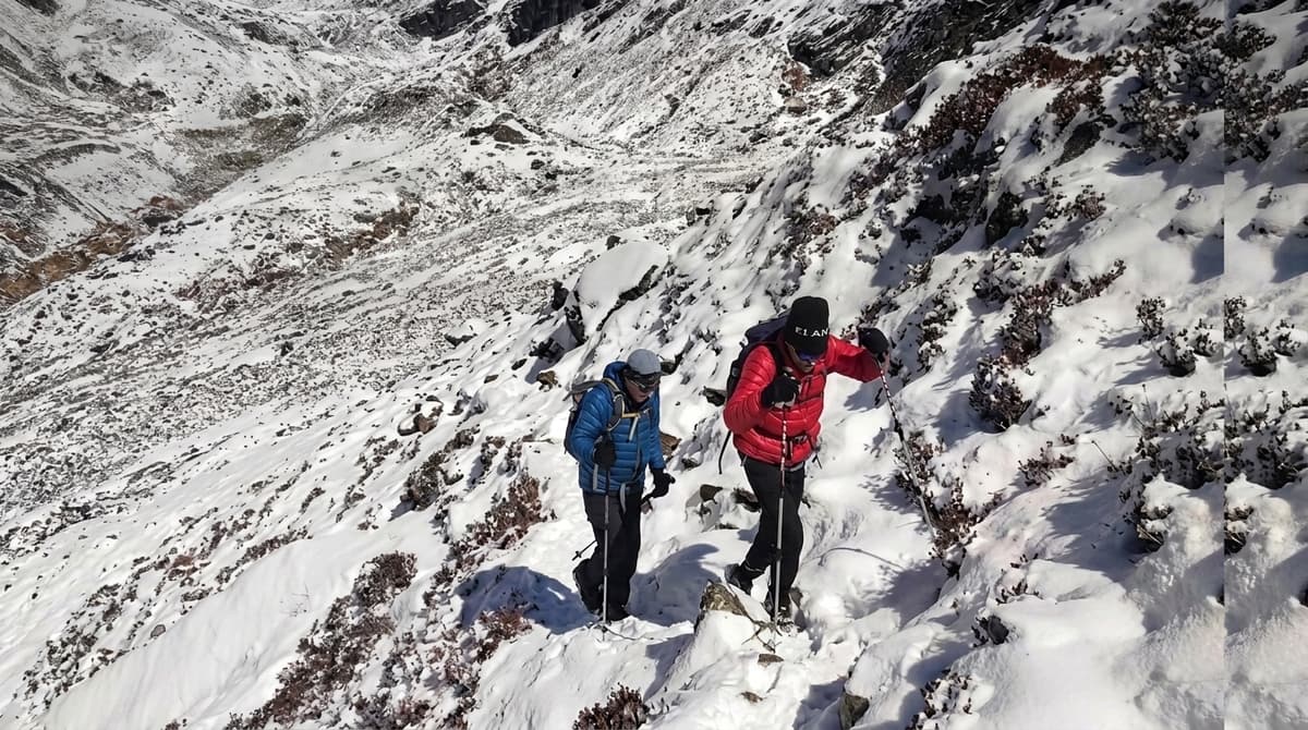 Trekkers crossing a high mountain pass on Nepal's Everest Three Passes Trek